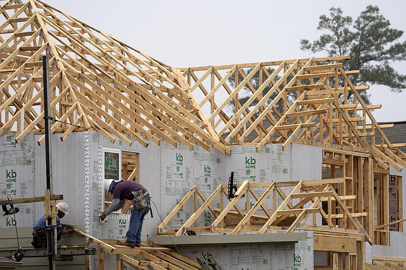 Construction workers build a new home Monday, March 15, 2021, in Houston. U.S. construction spending rose a modest 0.2% gain in April as strength in housing offset further weakness in nonresidential construction. (AP Photo/David J. Phillip)