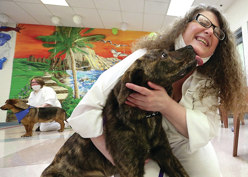 Hooch gives a kiss to his new trainer, McPherson Unit inmate Carolyn Arnett after they were matched up during the Paws in Prison kickoff "Paw-ty" on Tuesday, June 1, 2021, in Newport. Eight dogs were assigned to inmate trainers at the prison. 
More photos at www.arkansasonline.com/62pip/
(Arkansas Democrat-Gazette/Thomas Metthe)