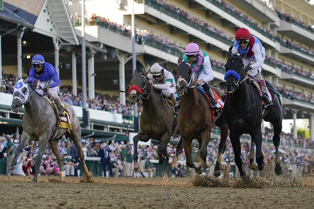 FILE - John Velazquez riding Medina Spirit, right, leads Florent Geroux on Mandaloun, Flavien Prat riding Hot Rod Charlie and Luis Saez on Essential Quality to win the 147th running of the Kentucky Derby at Churchill Downs in Louisville, Ky., in this Saturday, May 1, 2021, file photo. Essential Quality was set as a 2-1 favorite for the Belmont Stakes. Essential Quality went off as the Derby favorite and finished fourth. (AP Photo/Jeff Roberson, File)