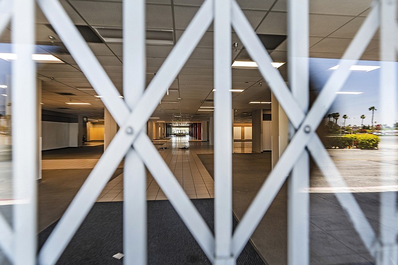 This Thursday, May 27, 2021, photo shows the closed Sears in Buena Park Mall in Buena Park, Calif. California state lawmakers are grappling with a particularly 21st-century problem: What to do with the growing number of shopping malls and big-box retail stores left empty by consumers shifting their purchases to the web. A possible answer in crowded California cities is to build housing on these sites, which already have ample parking and are close to existing neighborhoods. (AP Photo/Damian Dovarganes)