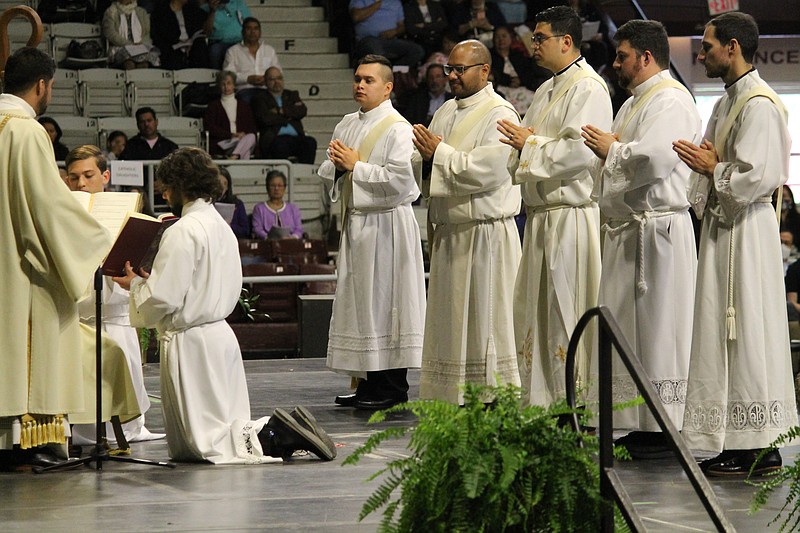 Recent ordinations of (left to right, from center) Alex Smith, Emmanuel Torres, Omar Galvan Gonzalez, Brian Cundall and Ben Riley to the Catholic priesthood were held at Barton Coliseum in Little Rock on May 29.
(Arkansas Democrat-Gazette/Francisca Jones)