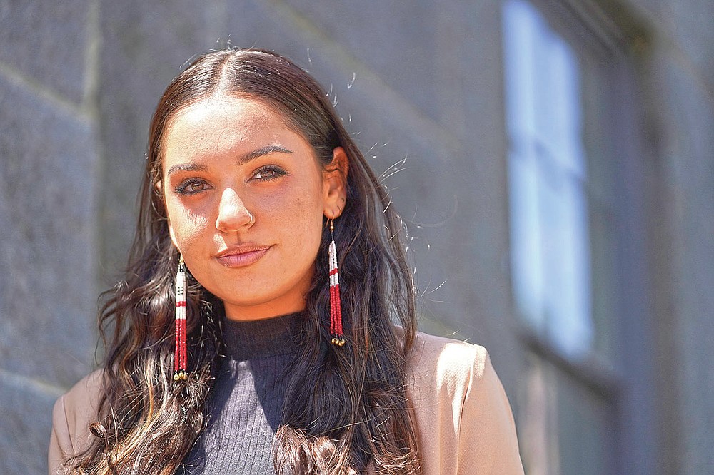Samantha Maltais, of New Bedford, Mass., an incoming Harvard Law student, stands for a photograph, Tuesday, May 25, 2021, in New Bedford. When Maltais steps onto Harvard's campus this fall, she'll become the first member of the Aquinnah Wampanoag tribe to attend its prestigious law school. "Coming from a tribal community in its backyard, I'm hyper aware of Harvard's impact," said Maltais, the 24-year-old daughter of her tribe's chairwoman. (AP Photo/Steven Senne)