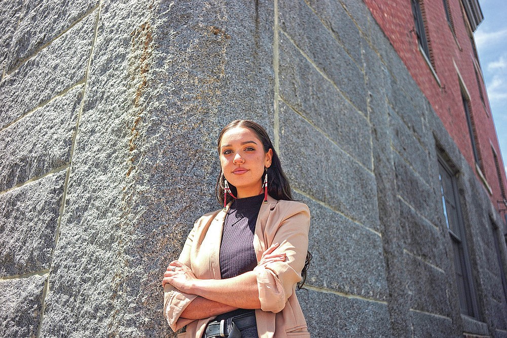 Samantha Maltais, of New Bedford, Mass., an incoming Harvard Law student, stands for a photograph, Tuesday, May 25, 2021, in New Bedford. When Maltais steps onto Harvard's campus this fall, she'll become the first member of the Aquinnah Wampanoag tribe to attend its prestigious law school. "Coming from a tribal community in its backyard, I'm hyper aware of Harvard's impact," said Maltais, the 24-year-old daughter of her tribe's chairwoman. (AP Photo/Steven Senne)