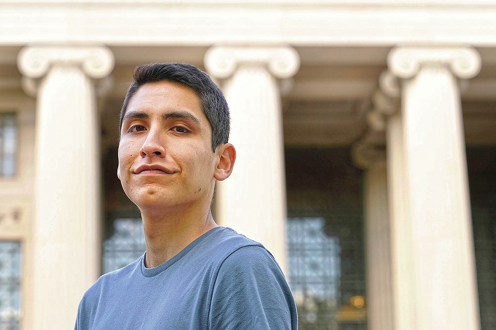 Luke Bastian, a 22-year-old Navajo student from Phoenix, stands for a photograph, Thursday, May 13, 2021, on the campus of Massachusetts Institute of Technology, in Cambridge, Mass. Bastian says he and other students presented their class projects to MIT's president earlier this month in the hopes of convincing the institution to create a Native American studies program. (AP Photo/Steven Senne)