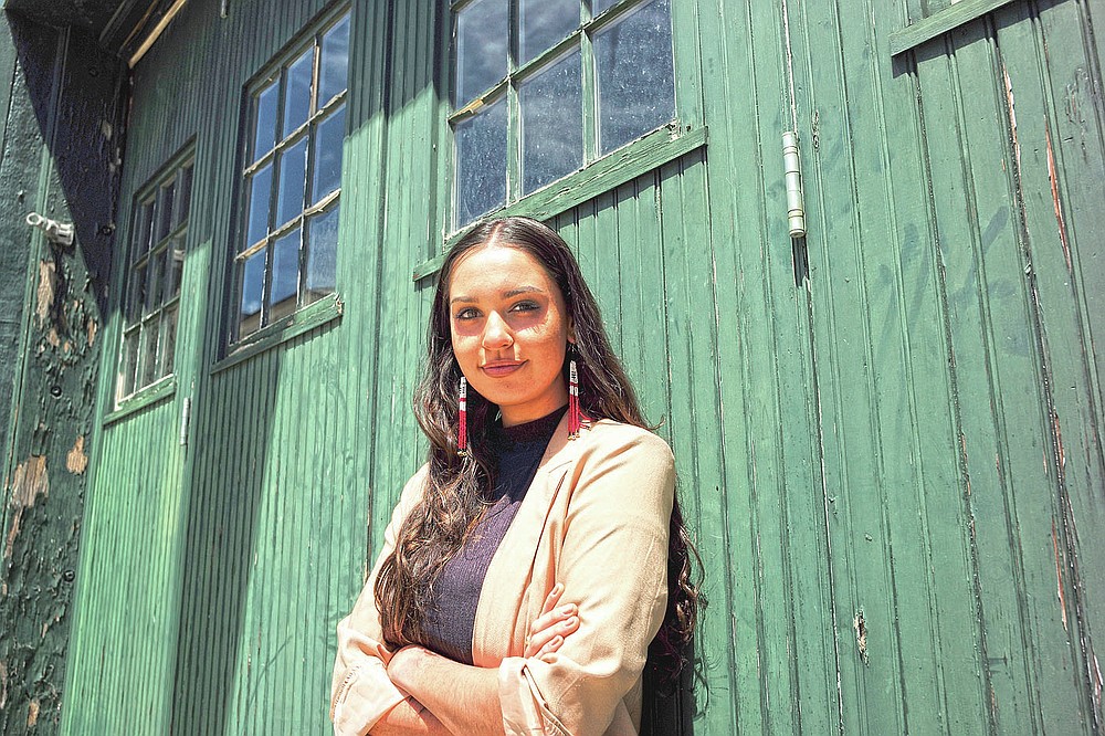 Samantha Maltais, of New Bedford, Mass., an incoming Harvard Law student, stands for a photograph, Tuesday, May 25, 2021, in New Bedford. When Maltais steps onto Harvard's campus this fall, she'll become the first member of the Aquinnah Wampanoag tribe to attend its prestigious law school. "Coming from a tribal community in its backyard, I'm hyper aware of Harvard's impact," said Maltais, the 24-year-old daughter of her tribe's chairwoman. (AP Photo/Steven Senne)