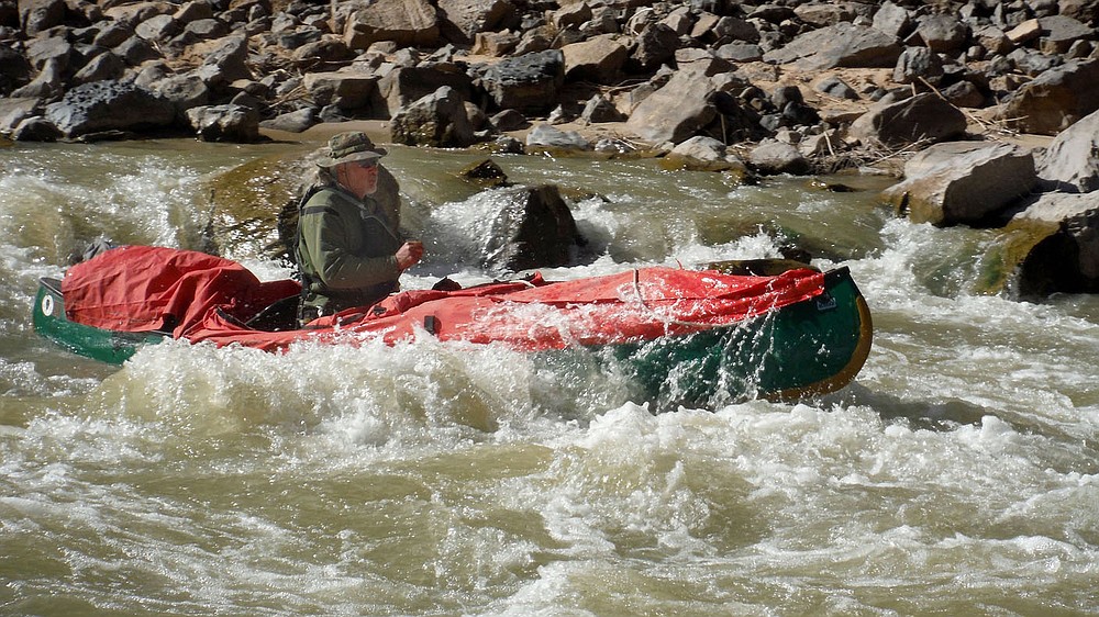 Bob Kramer paddles through a rapid in April 2021 on the San Juan River in southeast Utah. Sixteen people, including 12 canoes and a raft carrying four, paddled 83.5 miles of the San Juan River from the Sand Island Boat Ramp near Bluff, Utah to Clay Hills Crossing Utah.
(NWA Democrat-Gazette/David Gottschalk)