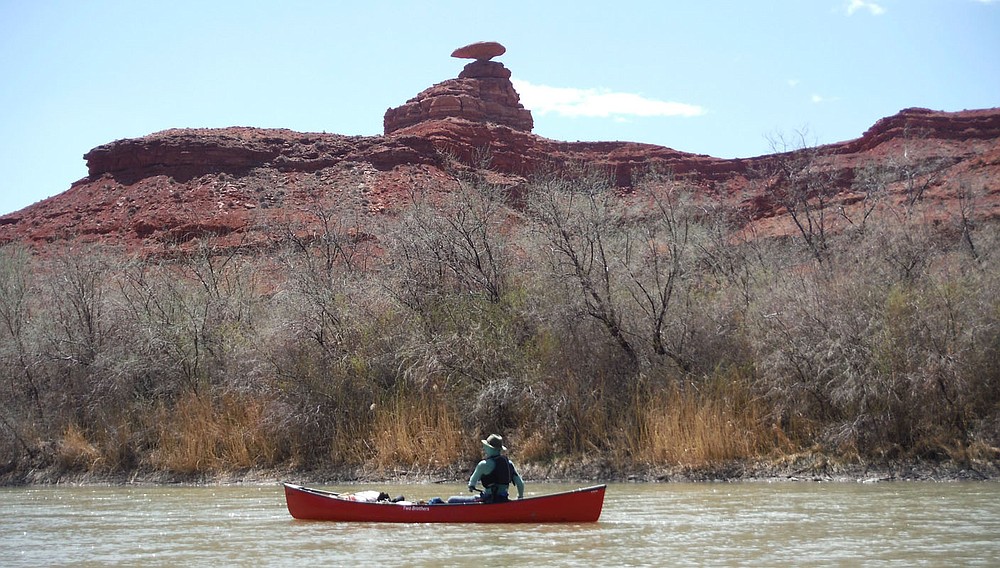 Patrick Davis floats a new Two Brothers Arkota canoe past the popular landmark Mexican Hat on the San Juan River in southeast Utah.
(NWA Democrat-Gazette/David Gottschalk)