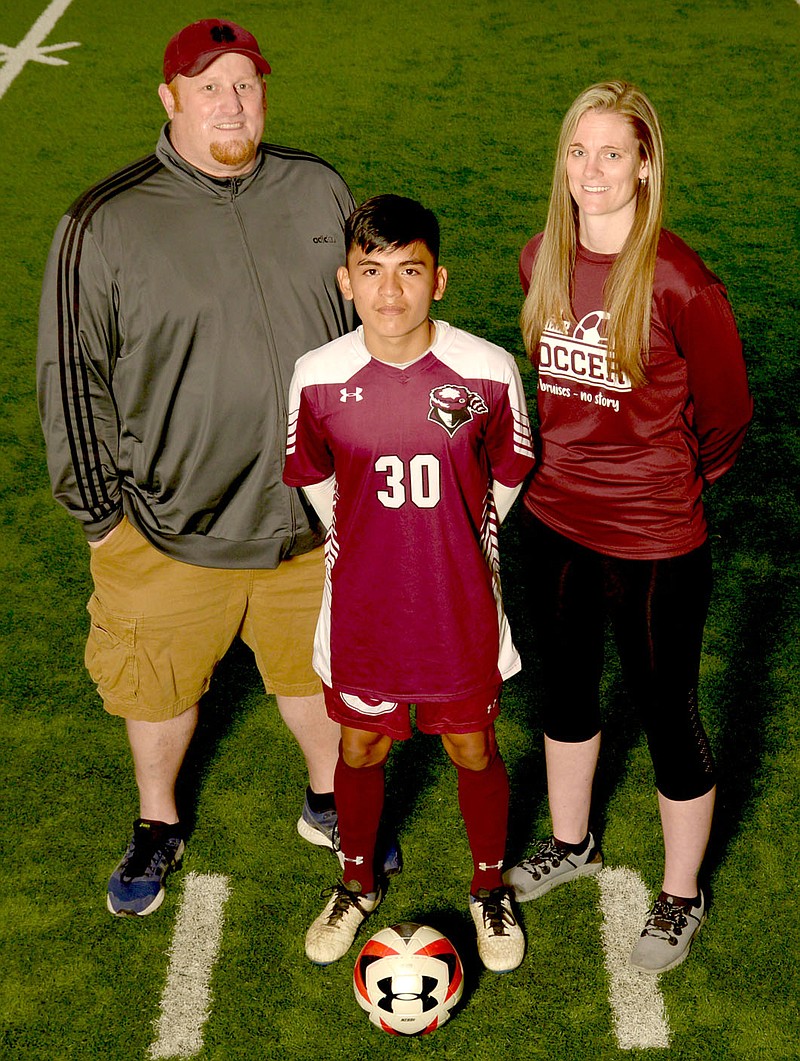 SUBMITTED
Edgar Reyes (center), a graduating senior at Gentry High School, is pictured with head boys soccer coach Drew Tingley and assistant boys soccer coach Jaimie Johnson. Reyes received 4A all-state honors for the third year in a row.