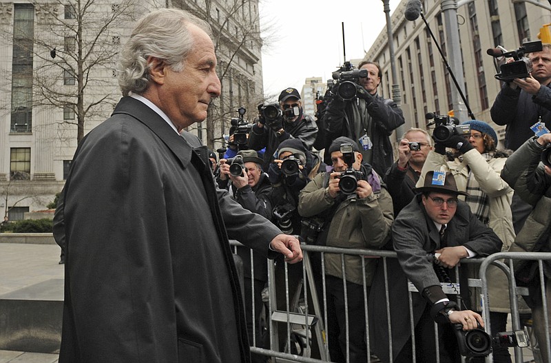 FILE - Bernard Madoff exits Manhattan federal court, Tuesday, March 10, 2009, in New York. The epic Ponzi scheme mastermind  is dead. But the effort to untangle his web of deceit lives on. More than 12 years after Madoff confessed to running the biggest financial fraud in Wall Street history, a team of lawyers is still at work on a sprawling effort to recover money for the thousands of victims of his scam.(AP Photo/ Louis Lanzano, File)