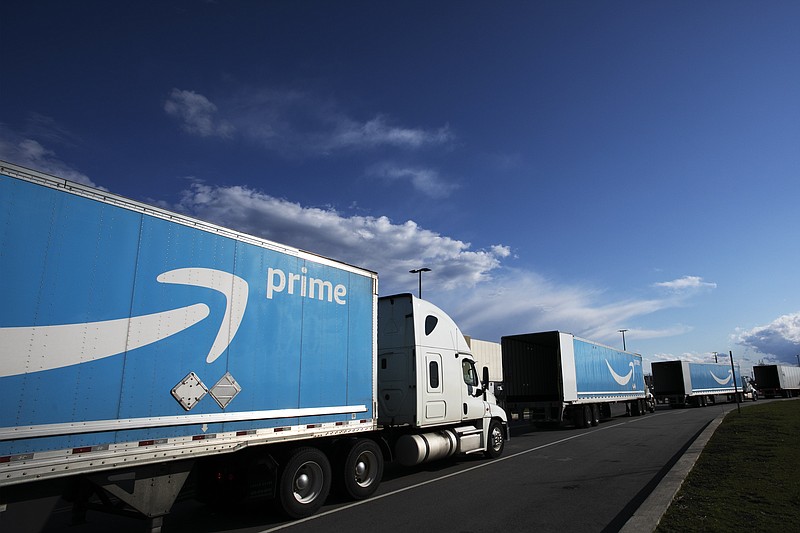 FILE - This April 21, 2020 file photo shows Amazon tractor trailers line up outside the Amazon Fulfillment Center in the Staten Island borough of New York.  Amazon said Wednesday, June 2, 2021,  that it will hold its annual Prime Day over two days in June this year, the earliest it has ever held the sales event.  (AP Photo/Mark Lennihan, File)