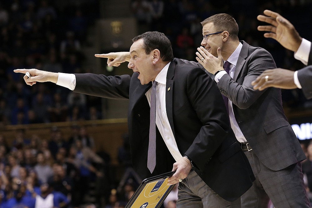 FILE - In this Nov. 26, 2019, file photo, Duke head coach Mike Krzyzewski directs his team as associate head coach Jon Scheyer shouts from behind him during the second half of an NCAA college basketball game against Stephen F. Austin in Durham, N.C. Duke Hall of Fame coach Mike Krzyzewski will coach his final season with the Blue Devils in 2021-22, a person familiar with the situation said Wednesday, June 2, 2021. The person said former Duke player and associate head coach Jon Scheyer would then take over as Krzyzewski's successor for the 2022-23 season. (AP Photo/Gerry Broome, File)