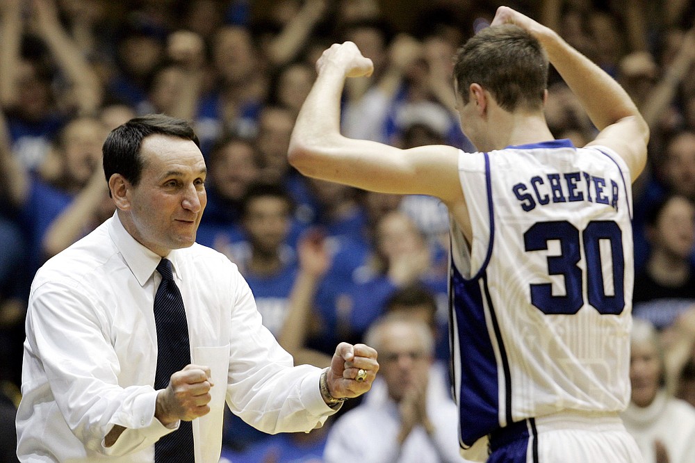 FILE- In this Feb. 22, 2009, file photo, Duke coach Mike Krzyzewski congratulates Jon Scheyer (30) late in the second half of an NCAA college basketball game against Wake Forest in Durham, N.C. Duke Hall of Fame coach Mike Krzyzewski will coach his final season with the Blue Devils in 2021-22, a person familiar with the situation said Wednesday, June 2, 2021. The person said former Duke player and associate head coach Jon Scheyer would then take over as Krzyzewski's successor for the 2022-23 season. (AP Photo/Gerry Broome, File)