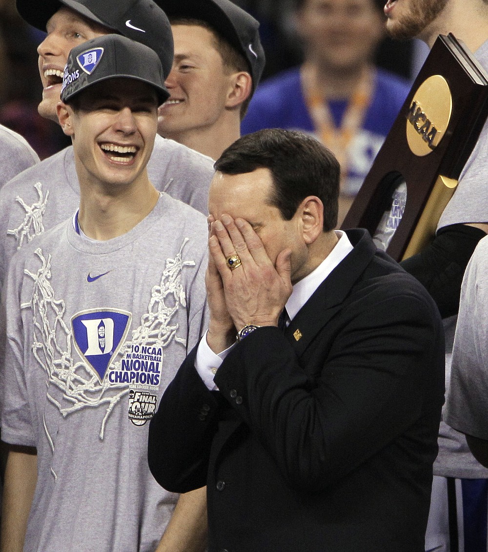 FILE - In this April 5, 2010, file photo, Duke head coach Mike Krzyzewski is overcome with emotion as guard Jon Scheyer looks on after Duke's 61-59 win over Butler in the NCAA Final Four college basketball championship game in Indianapolis. Duke Hall of Fame coach Mike Krzyzewski will coach his final season with the Blue Devils in 2021-22, a person familiar with the situation said Wednesday, June 2, 2021. The person said former Duke player and associate head coach Jon Scheyer would then take over as Krzyzewski's successor for the 2022-23 season. (AP Photo/Amy Sancetta, File)