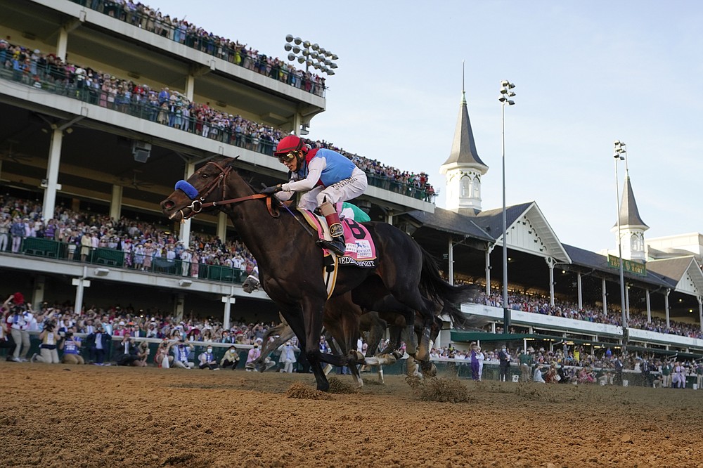 FILE - John Velazquez riding Medina Spirit crosses the finish line to win the 147th running of the Kentucky Derby at Churchill Downs in Louisville, Ky., in this Saturday, May 1, 2021, file photo. Bob Baffert’s lawyer said Wednesday, June 2, 2021, that a split-sample test of Kentucky Derby winner Medina Spirit came back positive for the presence of the steroid betamethasone, which could lead to the horse’s disqualification and discipline for the Hall of Fame trainer. (AP Photo/Jeff Roberson, File)