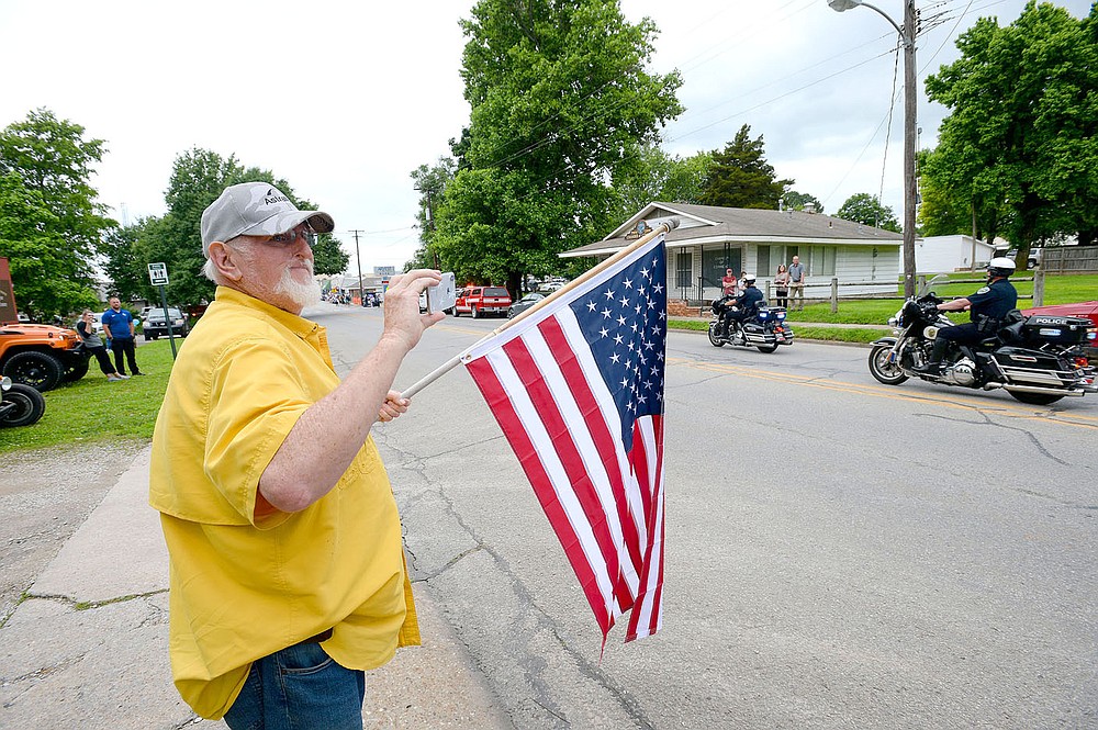 ANDY SHUPE NWA DEMOCRAT-GAZETTE
Residents hold flags and signs Wednesday, June 2, 2021, during a parade in downtown Prairie Grove to welcome home Tyler Franks, an officer with the Prairie Grove Police Department who was shot May 4 while responding to a domestic disturbance.