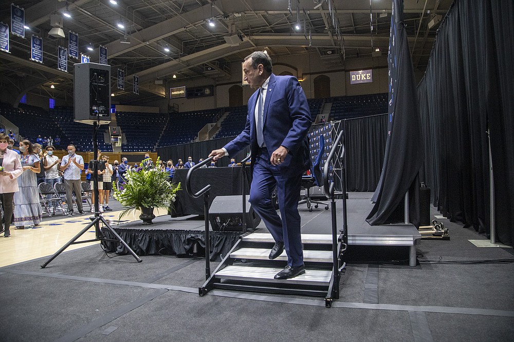 Duke University basketball coach Mike Krzyzewski walks off stage following an NCAA college basketball news conference  Thursday, June 3, 2021,  at Cameron Indoor Stadium in Durham, N.C. Krzyzewski, the winningest coach in the history of Division I men's college basketball announced that next season will be his last with the Blue Devils program he has built into one of college basketball’s bluebloods. The school named former Duke player and associate head coach Jon Scheyer as his successor for the 2022-23 season. (Travis Long/The News & Observer via AP)