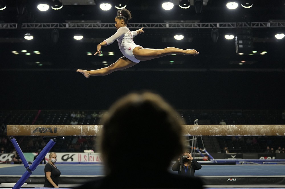 A judge watches as Jordan Chiles performs her balance-beam routine during the U.S. Classic gymnastics meet in Indianapolis, Saturday, May 22, 2021. (AP Photo/AJ Mast)