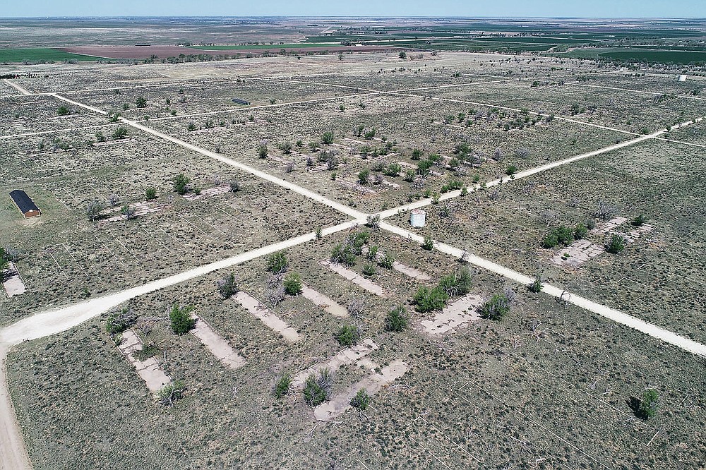 This photo shows the foundation of barracks at Camp Amache in Granada, Colo. on Thursday, May 6, 2021. The camp site, which covered 10,000 acres, was used for residential, community and administrative buildings, and agricultural projects for the more than 7,300 Japanese- Americans that were relocated here during WWII. (Hyoung Chang/The Denver Post via AP)