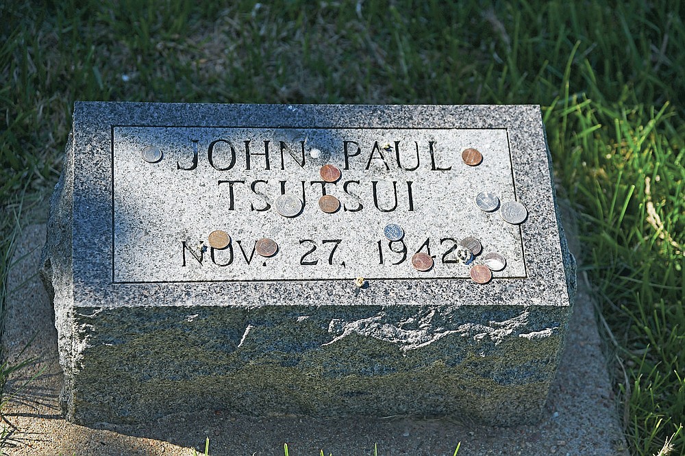 This photo shows the tombstone of John Paul Tsutsui at the cemetery of Camp Amache in Granada, Colo. Thursday, May 6, 2021. The camp site, which covered 10,000 acres, was used for residential, community and administrative buildings, and agricultural projects for the more than 7,300 Japanese- Americans that were relocated here during WWII. (Hyoung Chang/The Denver Post via AP)