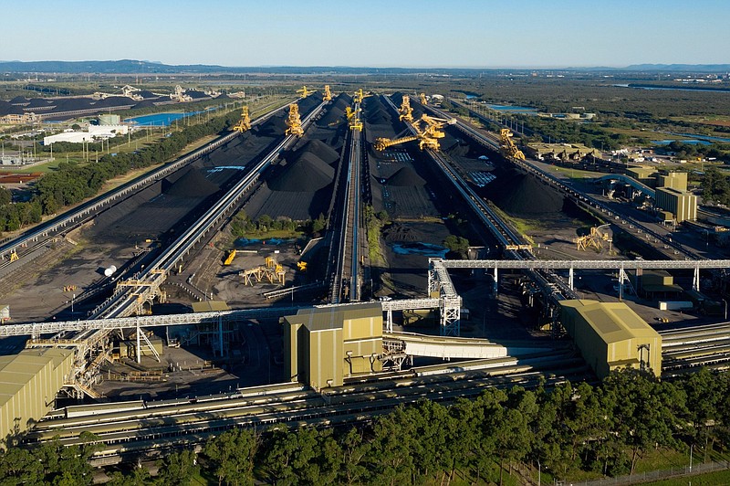 Stacker-reclaimers operate next to stockpiles of coal at the Newcastle Coal Terminal in Newcastle, New South Wales, Australia, on March 26, 2021. MUST CREDIT: Bloomberg photo by Brendon Thorne