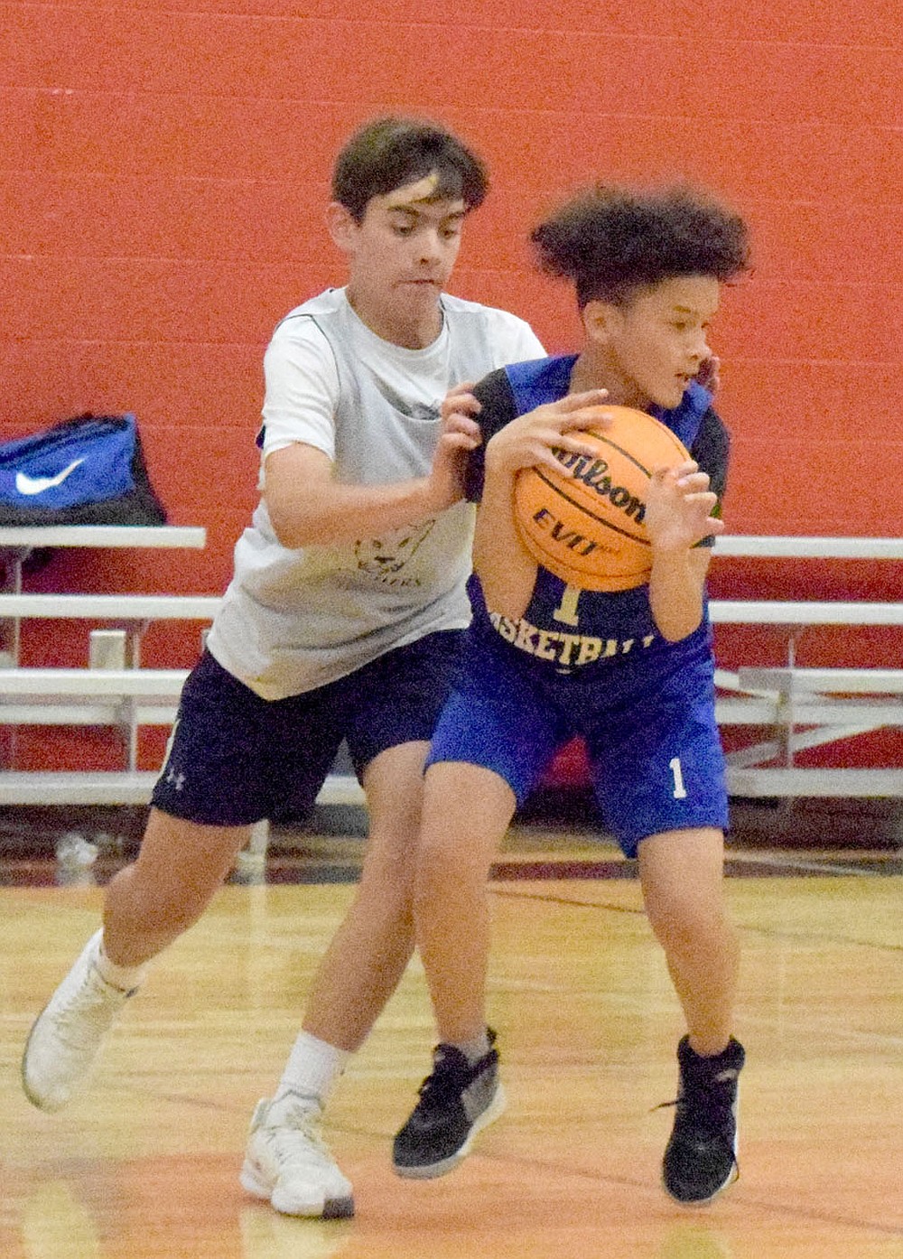 Westside Eagle Observer/MIKE ECKELS
Ricky Thor (1) latches onto a loose ball and holds on, keeping it out of the reach of a Panther player during the June 8 Decatur- St. Joseph Catholic junior high basketball contest in Fayetteville. The Panthers took the win 19-15 during the Arkansas Athletics Outreach team camp.