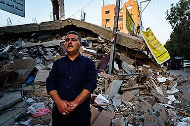 Samir Mansour stands before the remains of his bookstore, a Gaza cultural lodestar, destroyed in an Israeli bombardment during the last escalation, which lasted 11 days between Israel and Gaza military factions, in Gaza City, Wednesday, May 26, 2021. (Marcus Yam/Los Angeles Times/TNS)