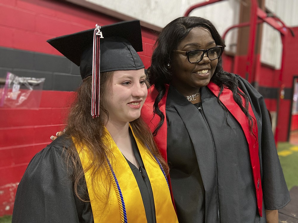 Gabrielle Hutchinson and Tybresha Lewis pose for photos prior to the graduation ceremony at West Lauderdale High School in Collinsville, Miss on Monday, May 17 2021. (Bill Graham/The Meridian Star via AP)