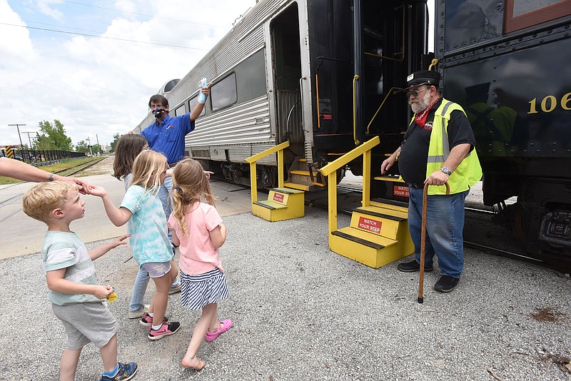 Mitch Marmel with Arkansas & Missouri Railroad welcomes passengers aboard a train Saturday during the Founder's Day celebration, honoring the 140th birthday of the city of Rogers. The city was founded along the Frisco Railroad line in 1881. Go to nwaonline.com/210606Daily/ to see more photos.
(NWA Democrat-Gazette/Flip Putthoff)