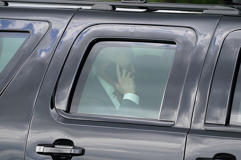 President Joe Biden speaks on his phone after he and first lady Jill Biden arrived on the Ellipse near the White House, Friday, June 4, 2021, in Washington. Biden returns to the White House after spending a few days in Rehoboth Beach to celebrate first lady Jill Biden's 70th birthday. (AP Photo/Evan Vucci)