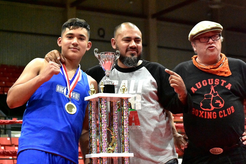 Eddie Montes of Springdale, left, poses with father and trainer Poncho Montes and Arkansas USA Boxing local commission President Bryon Hurford after winning the Ray Rogers Award at the Arkansas State Silver Gloves on Saturday, June 5, 2021, at the Pine Bluff Convention Center. (Pine Bluff Commercial/I.C. Murrell)