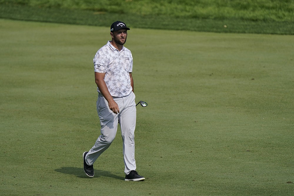 Jon Rahm walks to the 15th green during the third round of the Memorial golf tournament, Saturday, June 5, 2021, in Dublin, Ohio. Rahm was later notified he tested positive for the coronavirus, knocking him out of the tournament. (AP Photo/Darron Cummings)
