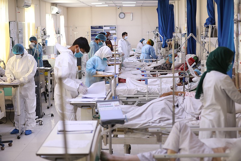 Afghan doctors check a COVID-19 patient files at the Afghan-Japan Communicable Disease Hospital in Kabul, Afghanistan, Sunday, May 30, 2021. Afghanistan is battling a brutal third wave of COVID infections, while health officials plead for vaccines, expressing deep frustration at the inequities of the global vaccine distribution. Positive COVID cases jump from eight percent to 60 per cent in some parts of the country. (AP Photo/Rahmat Gul)