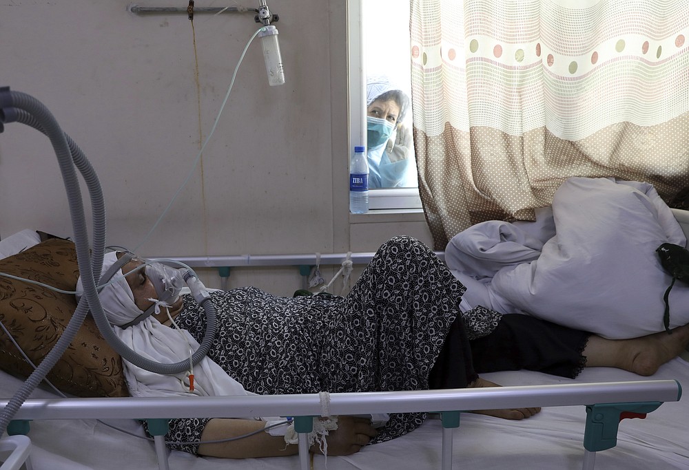A patient is connected to oxygen tank in the intensive care unit ward for COVID-19 patients at the Afghan-Japan Communicable Disease Hospital in Kabul, Afghanistan, Sunday, May 30, 2021. Afghanistan is battling a brutal third wave of COVID infections, while health officials plead for vaccines, expressing deep frustration at the inequities of the global vaccine distribution. Positive COVID cases jump from eight percent to 60 per cent in some parts of the country. (AP Photo/Rahmat Gul)