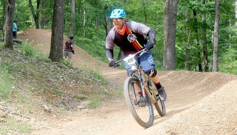 Keith Bryant/The Weekly Vista
Brandt Oliver hustles through a berm after a massive tabletop on the Bella Vista Enduro's second stage.