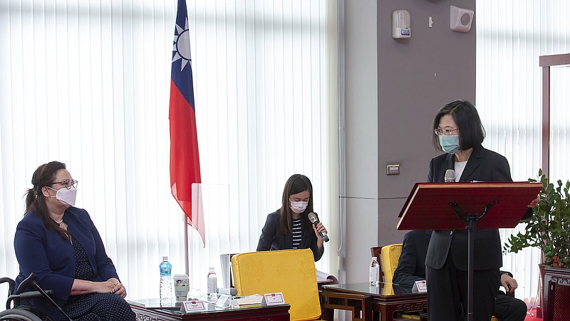 In this photo released by the Taiwan Presidential Office, President Tsai Ing-wen at right speaks near U.S. Democratic Sen. Tammy Duckworth of Illinois in Taipei, Taiwan on Sunday, June 6, 2021. The U.S. will give Taiwan 750,000 doses of COVID-19 vaccine, part of President Joe Biden's move to share tens of millions of jabs globally, three American senators said Sunday, after the self-ruled island complained that China is hindering its efforts to secure vaccines as it battles an outbreak. (Taiwan Presidential Office via AP)