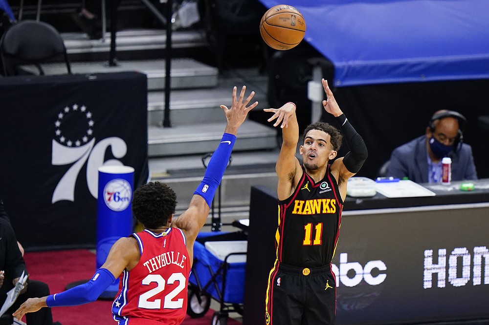 Atlanta Hawks' Trae Young (11) goes up for a shot against Philadelphia 76ers' Matisse Thybulle (22) during the second half of Game 1 of a second-round NBA basketball playoff series, Sunday, June 6, 2021, in Philadelphia. (AP Photo/Matt Slocum)