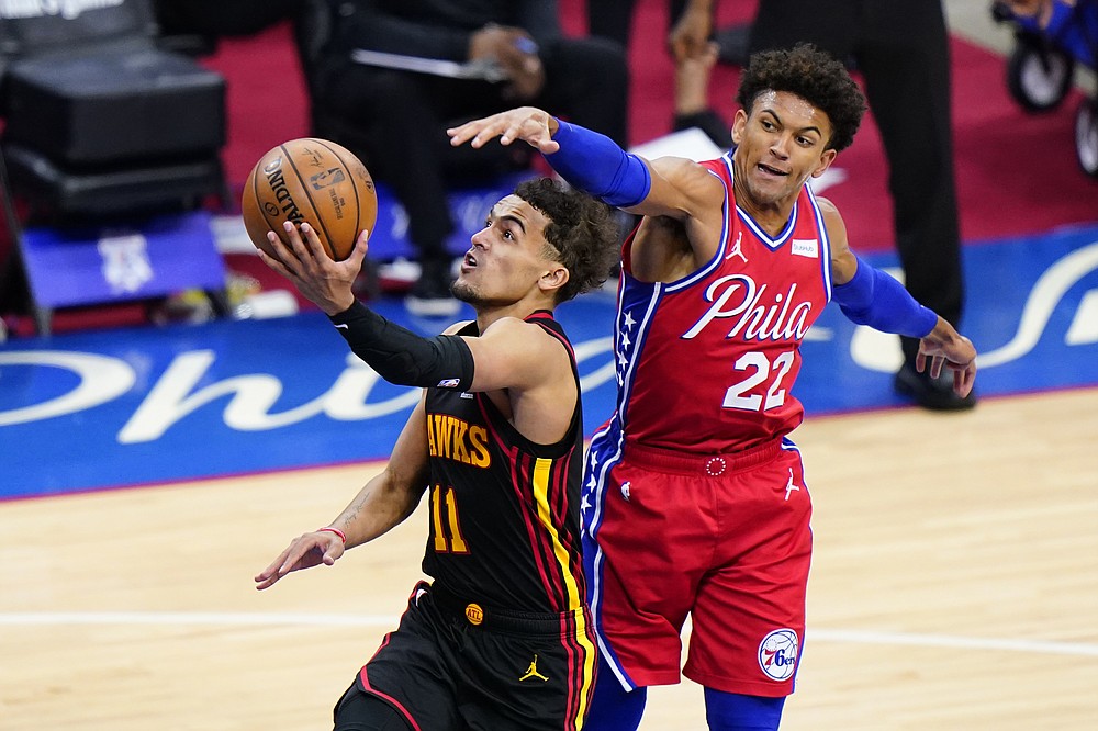 Atlanta Hawks' Trae Young, left, goes up for a shot past Philadelphia 76ers' Matisse Thybulle during the second half of Game 1 of a second-round NBA basketball playoff series, Sunday, June 6, 2021, in Philadelphia. (AP Photo/Matt Slocum)