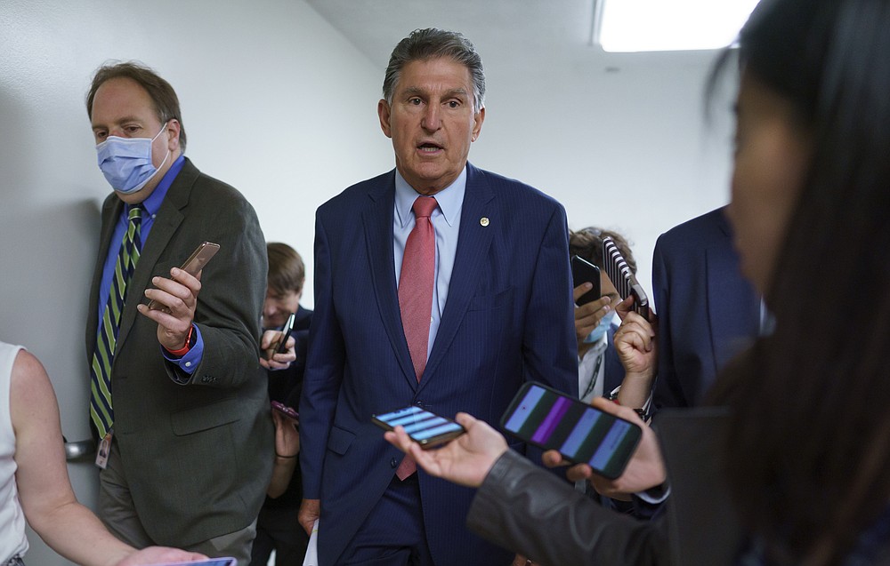 Sen. Joe Manchin, D-W.Va., is surrounded by reporters as senators rush to the chamber for votes ahead of the approaching Memorial Day recess, at the Capitol in Washington, Wednesday, May 26, 2021. Lawmakers still face standoffs on an infrastructure bill, police reform, voting rights, and a bipartisan commission to investigate the Jan. 6 attack on the Capitol. (AP Photo/J. Scott Applewhite)