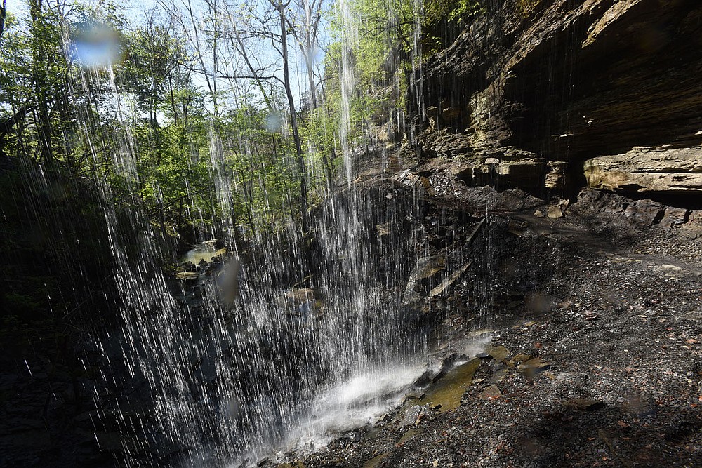 Hikers and off-road bikers follow April 2021 a trail behind Yellow Rock Falls.
(NWA Democrat-Gazette/Flip Putthoff)