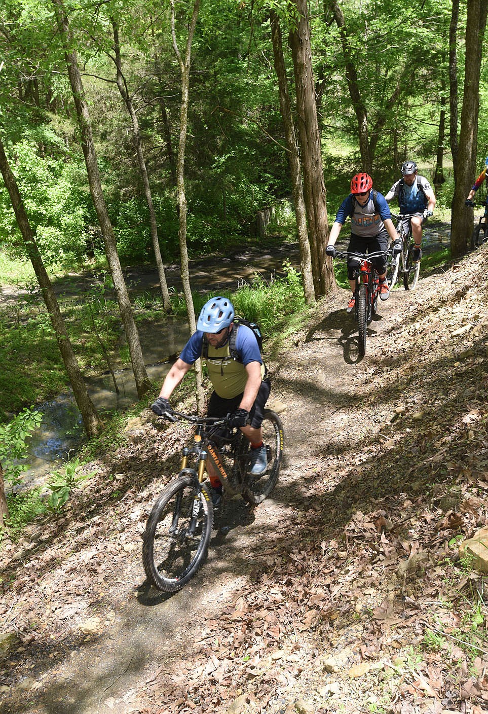 Bikers pedal May 6 2021 along the new Monument Trails system at Devil's Den State Park south of West Fork after dedication ceremonies at the trailhead.
(NWA Democrat-Gazette/Flip Putthoff)