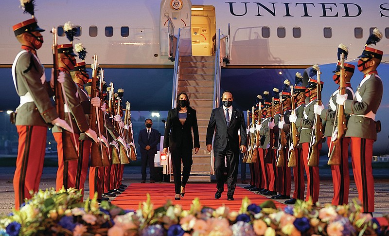 Vice President Kamala Harris walks with Guatemala's Minister of Foreign Affairs Pedro Brolois as she exits Air Force Two on arrival in Guatemala City, Sunday, June 6, 2021, at Guatemalan Air Force Central Command. (AP Photo/Jacquelyn Martin)