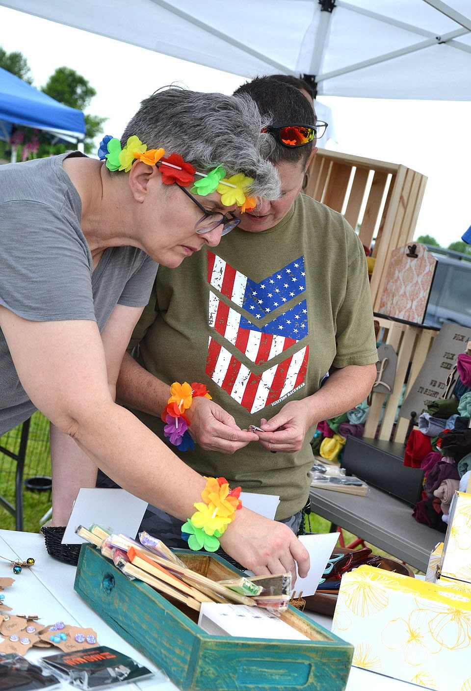Shoppers look through items at the Broken Window boutique booth at the Pea Ridge Community Library Summer Reading Kickoff event Saturday, June 5.