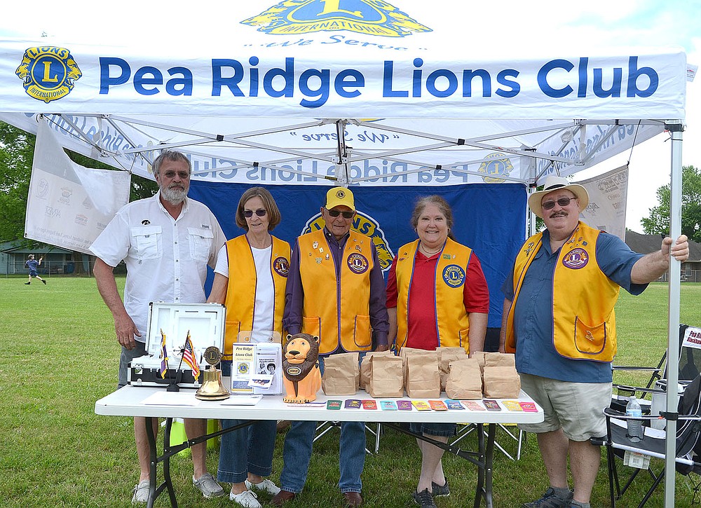 Members of the Pea Ridge Lions Club Steve and Jeanne Hasbrouck, Keith Escue and Renee and Donald Broussard manned a booth at the Saturday event for the Pea Ridge Community Library.