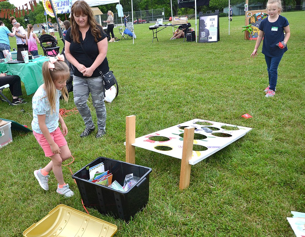 After successfully tossing the bean bag in the holes, one little girl headed for the treasure chest to gather her prize at the Pea Ridge Community Library Summer Reading Kickoff event Saturday, June 5.