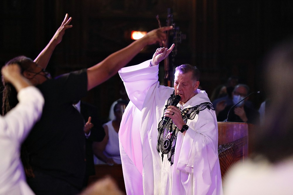 Rev. Michael Pfleger conducts his first Sunday church service as a senior pastor at St. Sabina Catholic Church following his reinstatement by Archdiocese of Chicago after decades-old sexual abuse allegations against minors, Sunday, June 6, 2021, in the Auburn Gresham neighborhood in Chicago. (AP Photo/Shafkat Anowar)