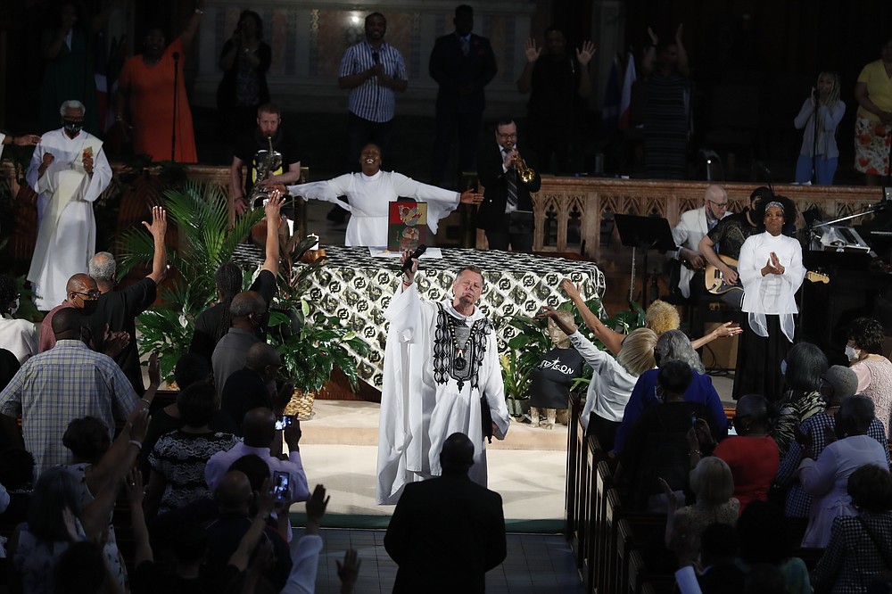 Rev. Michael Pfleger conducts his first Sunday church service as a senior pastor at St. Sabina Catholic Church following his reinstatement by Archdiocese of Chicago after decades-old sexual abuse allegations against minors, Sunday, June 6, 2021, in the Auburn Gresham neighborhood in Chicago. (AP Photo/Shafkat Anowar)