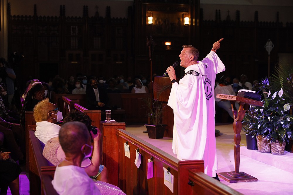 Rev. Michael Pfleger conducts his first Sunday church service as a senior pastor at St. Sabina Catholic Church following his reinstatement by Archdiocese of Chicago after decades-old sexual abuse allegations against minors, Sunday, June 6, 2021, in the Auburn Gresham neighborhood in Chicago. (AP Photo/Shafkat Anowar)