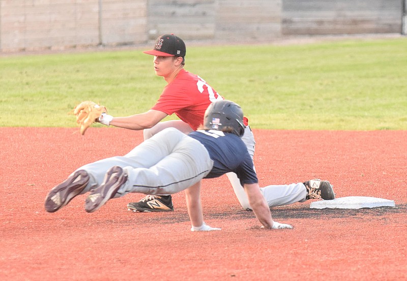 RICK PECK/SPECIAL TO MCDONALD COUNTY PRESS McDonald County shortstop Tucker Walters tags out a Joplin runner during McDonald County's 2-2 tie with Joplin in an 8-on-8 league game on June 2 at Joe Becker Stadium in Joplin.