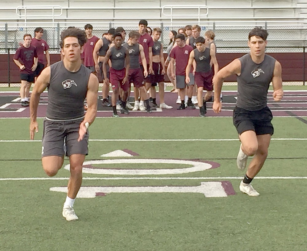 Graham Thomas/Herald-Leader
Siloam Springs senior Christian Ledeker, left, and sophomore Mason Simmons run sprints during Panther Pride workouts on Monday morning at Panther Stadium.