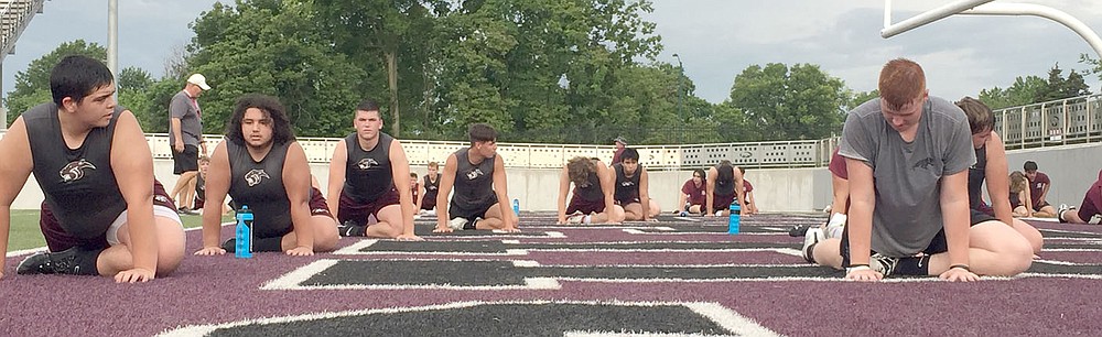 Graham Thomas/Herald-Leader
Siloam Springs football players stretch toward the end of Monday's Panther Pride workout at Panther Stadium.